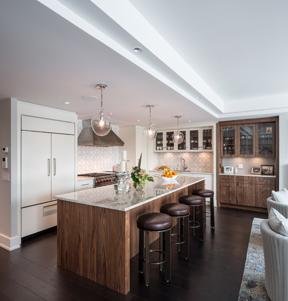 Mid-sized contemporary l-shaped eat-in kitchen in Ottawa with an undermount sink, flat-panel cabinets, white cabinets, quartz benchtops, stainless steel appliances, dark hardwood floors, with island, multi-coloured splashback, mosaic tile splashback and brown floor.