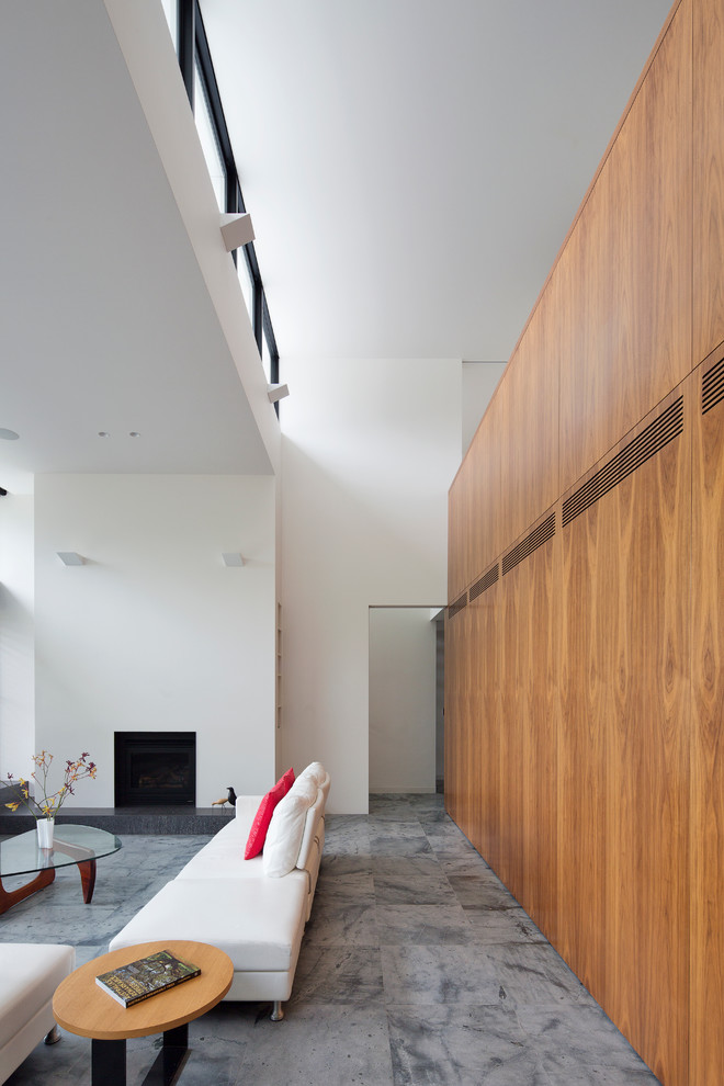 This is an example of a large contemporary open concept living room in Sydney with white walls, a standard fireplace, a plaster fireplace surround and no tv.
