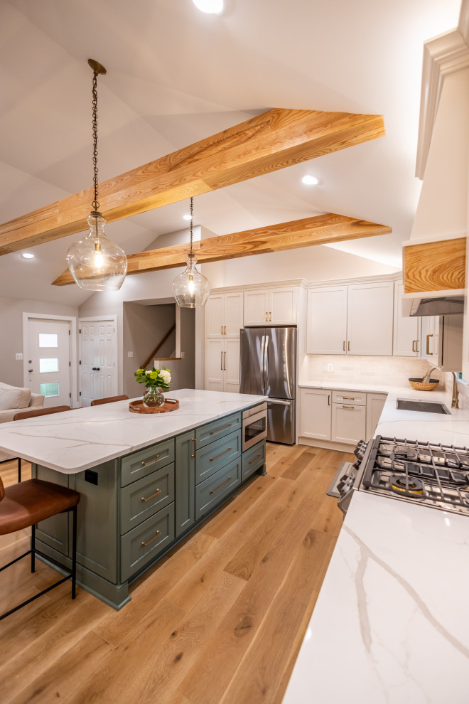 Inspiration for a large transitional l-shaped light wood floor, brown floor and exposed beam eat-in kitchen remodel in DC Metro with an undermount sink, shaker cabinets, quartz countertops, white backsplash, porcelain backsplash, stainless steel appliances, an island and white countertops