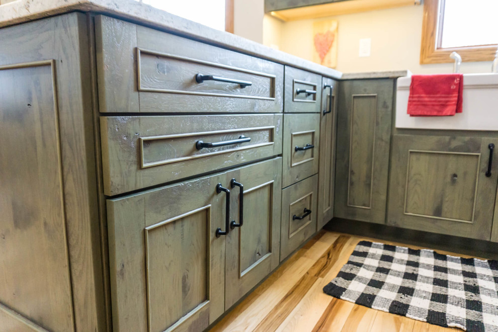 Inspiration for a large rustic light wood floor and brown floor open concept kitchen remodel with beaded inset cabinets, distressed cabinets, granite countertops, an island and white countertops
