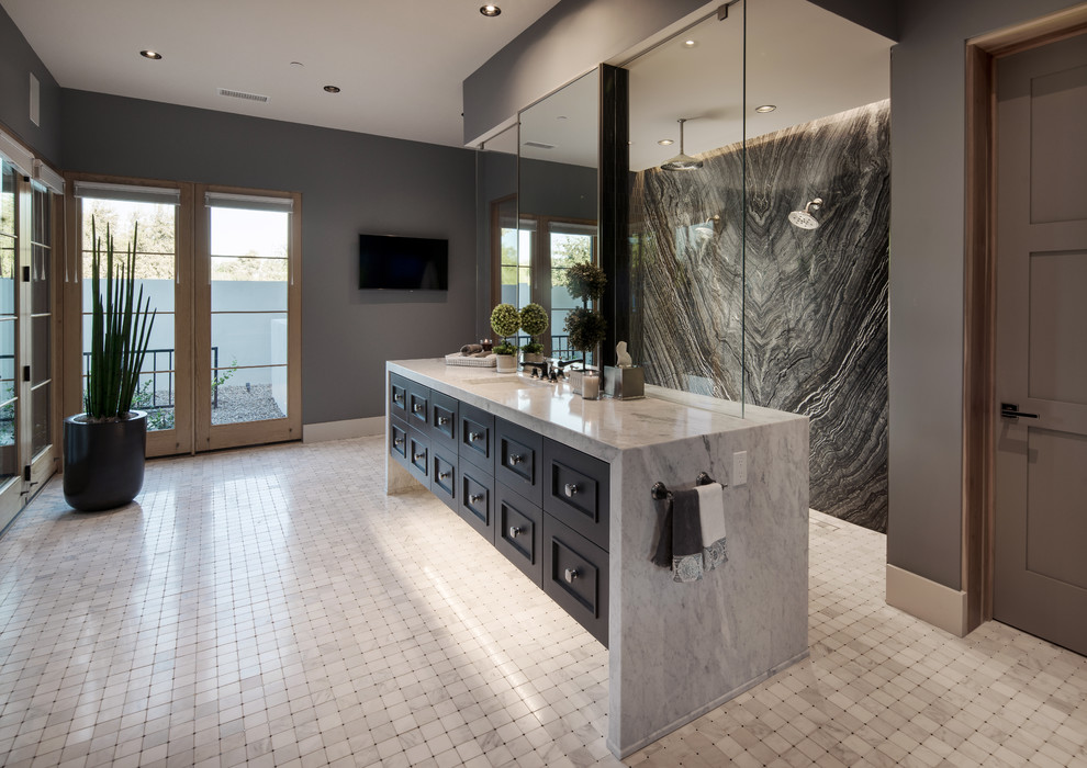 Photo of a country master bathroom in Phoenix with recessed-panel cabinets, black cabinets, black and white tile, stone slab, grey walls, marble floors, an undermount sink, white floor and grey benchtops.