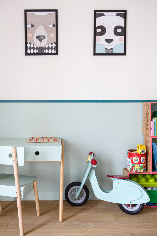 Cette image montre une chambre d'enfant de 4 à 10 ans minimaliste de taille moyenne avec un mur multicolore, parquet clair, un sol beige et du papier peint.