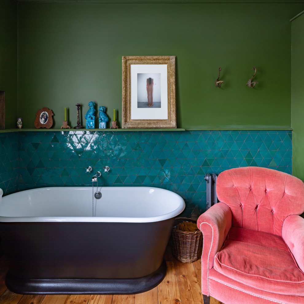 Photo of a medium sized eclectic ensuite bathroom in London with a freestanding bath, green tiles, a single sink and a floating vanity unit.