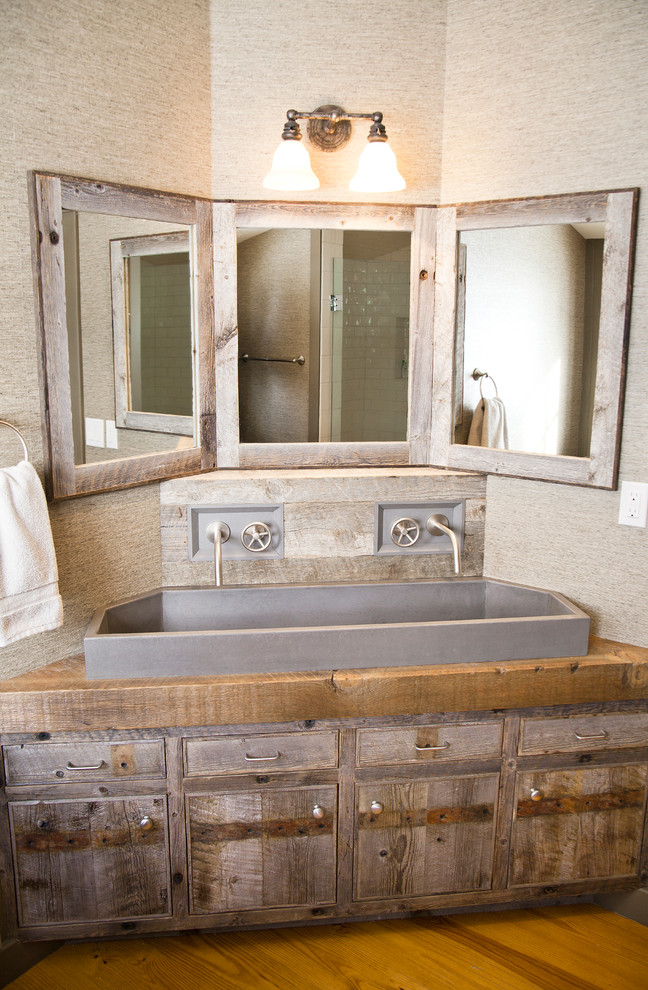 Mountain style bathroom photo with a trough sink and wood countertops