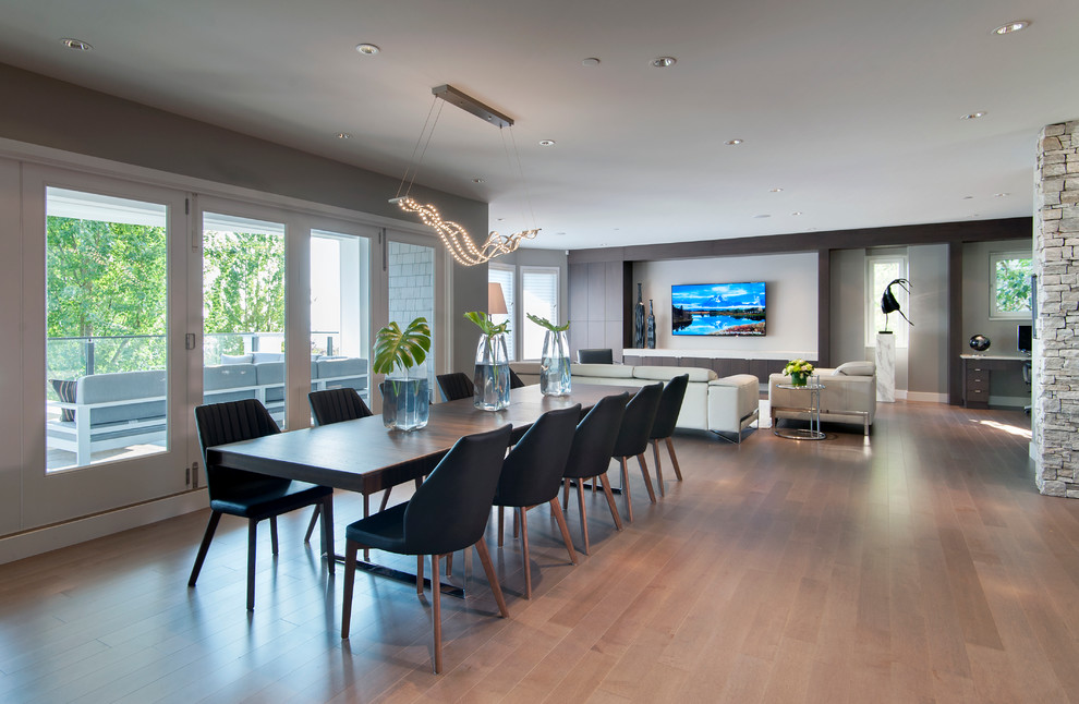 Photo of an expansive contemporary open plan dining in Vancouver with grey walls and medium hardwood floors.