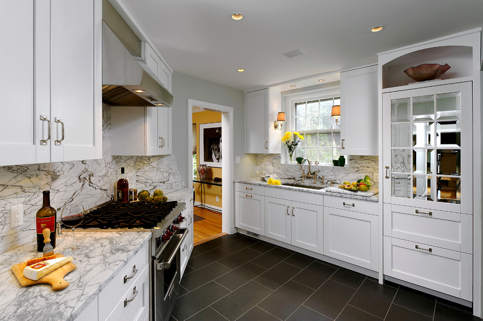 Mid-sized traditional l-shaped eat-in kitchen in DC Metro with an undermount sink, shaker cabinets, white cabinets, granite benchtops, multi-coloured splashback, ceramic splashback, stainless steel appliances, with island and porcelain floors.