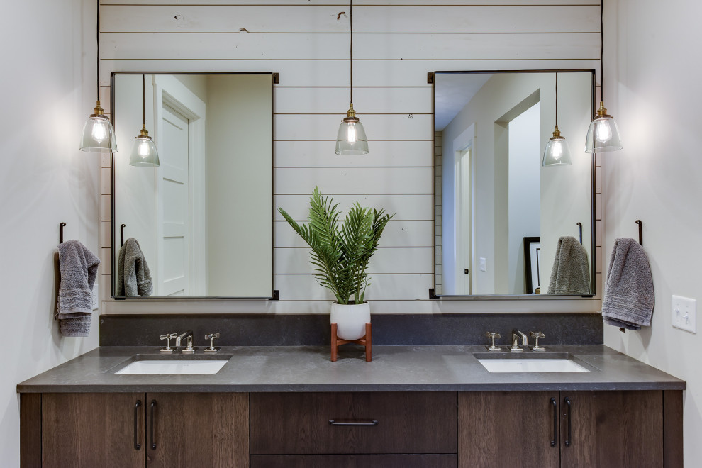 Photo of a mid-sized country master bathroom in Minneapolis with brown cabinets, a freestanding tub, an alcove shower, a one-piece toilet, white tile, subway tile, grey walls, limestone floors, a drop-in sink, engineered quartz benchtops, grey floor, a hinged shower door, grey benchtops and flat-panel cabinets.