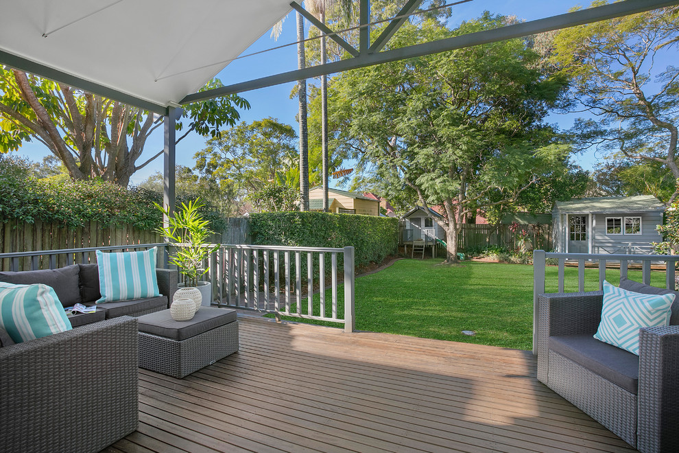 Inspiration for a mid-sized transitional backyard verandah in Sydney with decking and a roof extension.