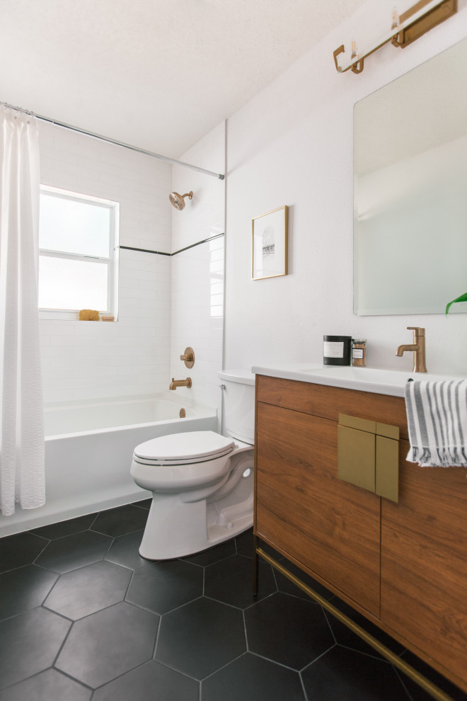 This is an example of a small scandinavian master bathroom in Tampa with flat-panel cabinets, brown cabinets, an alcove tub, an alcove shower, white tile, subway tile, white walls, ceramic floors, an integrated sink, engineered quartz benchtops, black floor, a shower curtain, white benchtops, a single vanity and a freestanding vanity.