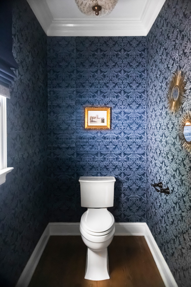 Mid-sized traditional powder room in Cleveland with shaker cabinets, white cabinets, blue walls, medium hardwood floors, an undermount sink, engineered quartz benchtops, white benchtops, a built-in vanity and wallpaper.