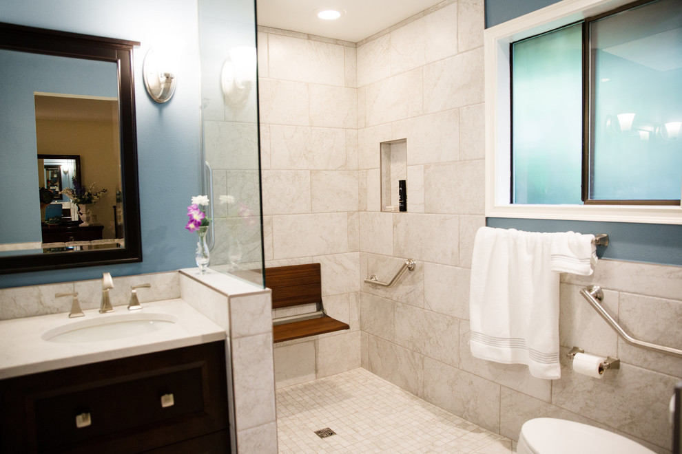Doorless shower - mid-sized transitional master gray tile and porcelain tile porcelain tile doorless shower idea in Seattle with flat-panel cabinets, dark wood cabinets, blue walls, an undermount sink and quartz countertops