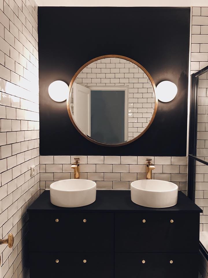 Photo of a mid-sized contemporary master wet room bathroom in Paris with beaded inset cabinets, black cabinets, a corner tub, white tile, black tile, matchstick tile, a trough sink, wood benchtops, a hinged shower door and black benchtops.
