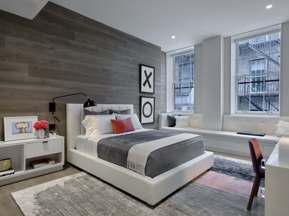 Design ideas for a large contemporary guest bedroom in New York with grey walls, light hardwood floors and grey floor.