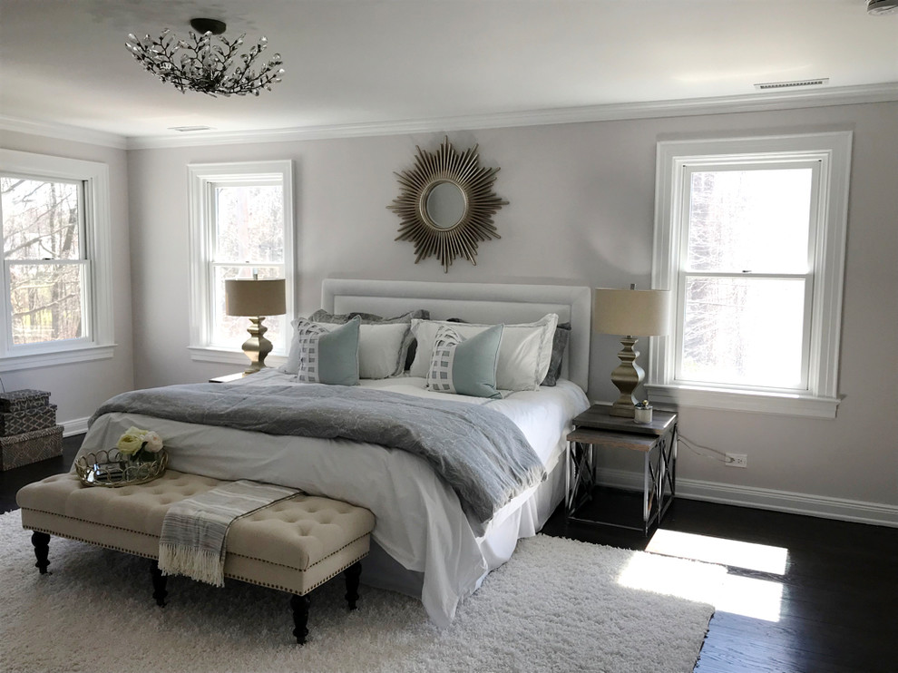 Inspiration for a large contemporary master bedroom in New York with grey walls, dark hardwood floors, no fireplace and brown floor.