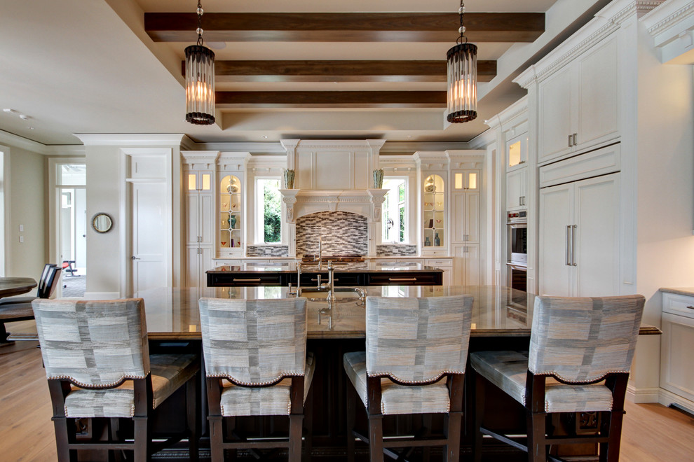 Kitchen - large transitional l-shaped medium tone wood floor and brown floor kitchen idea in Miami with an undermount sink, recessed-panel cabinets, white cabinets, multicolored backsplash, glass tile backsplash, paneled appliances and two islands