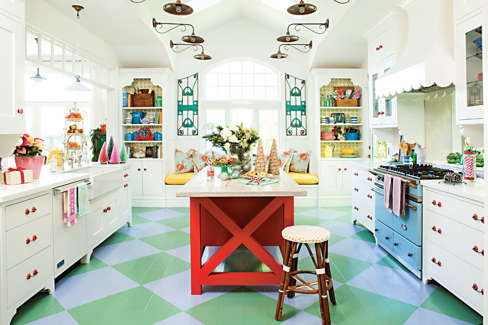 Design ideas for a large eclectic u-shaped open plan kitchen in Los Angeles with a farmhouse sink, shaker cabinets, coloured appliances, painted wood floors, multi-coloured floor and white cabinets.