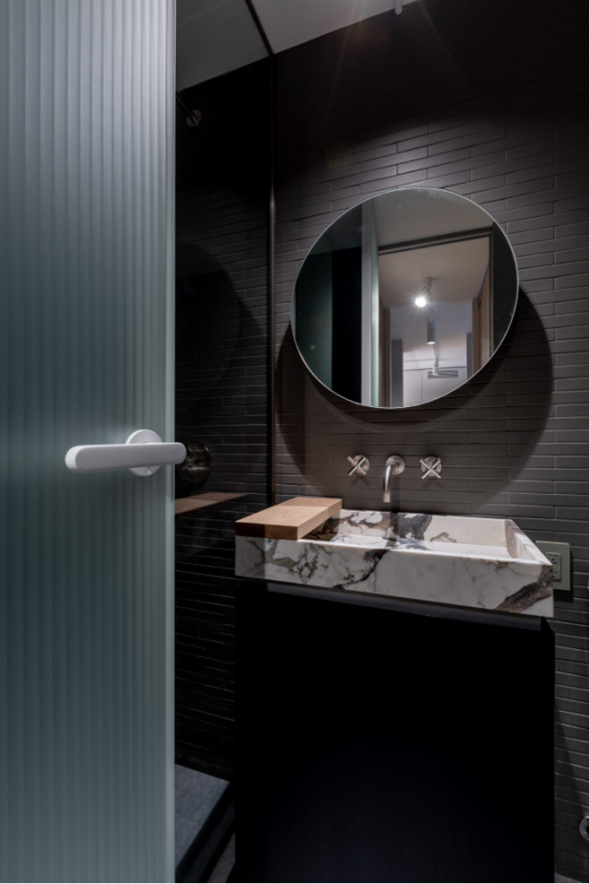 Photo of a large modern 3/4 wet room bathroom in New York with shaker cabinets, black cabinets, gray tile, matchstick tile, grey walls, a trough sink, marble benchtops, an open shower, a single vanity and a built-in vanity.