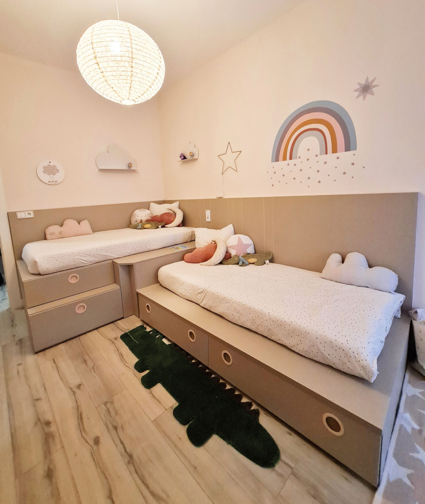 This is an example of a small traditional kids' bedroom for kids 4-10 years old with pink walls.