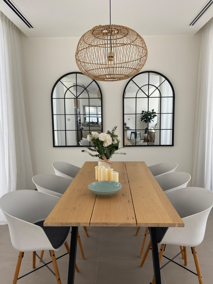 This is an example of a small country enclosed dining room in Other with white walls and limestone flooring.
