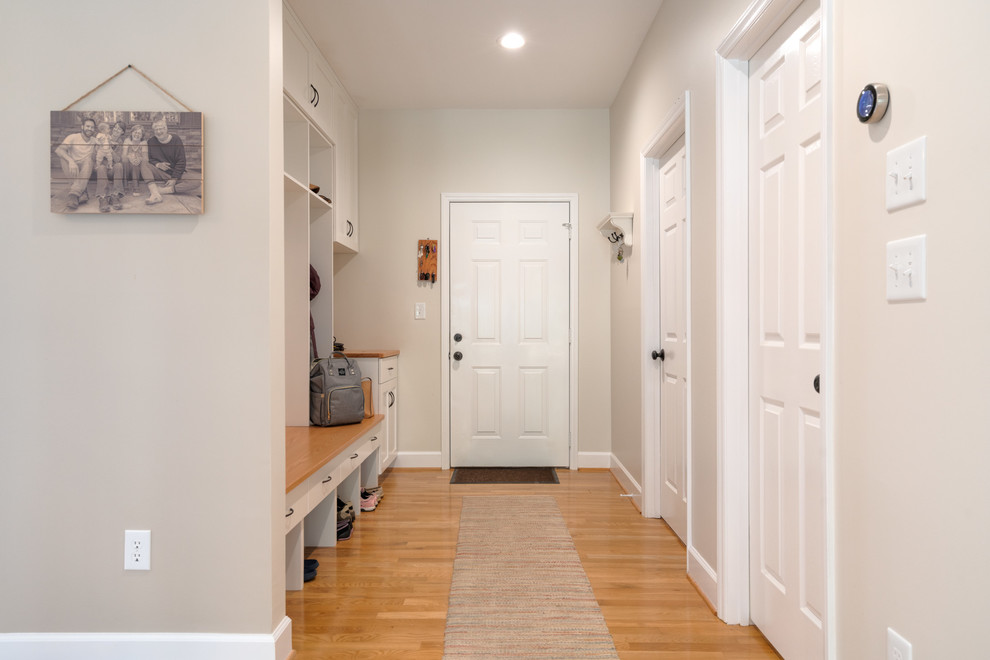 Inspiration for a mid-sized transitional light wood floor mudroom remodel