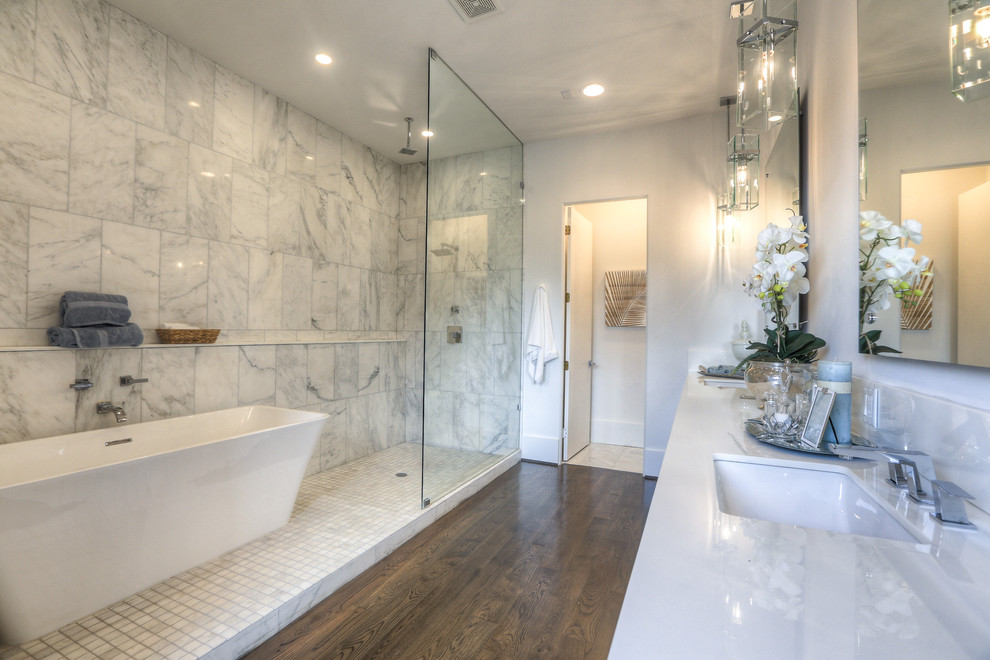 Inspiration for a large transitional master bathroom in Houston with an undermount sink, a freestanding tub, an open shower, dark hardwood floors, an open shower, a two-piece toilet, white tile, marble, white walls, engineered quartz benchtops, brown floor and white benchtops.