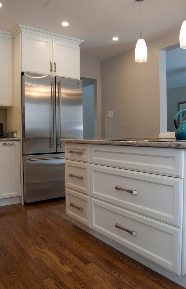 Example of a transitional kitchen design in Ottawa with an island