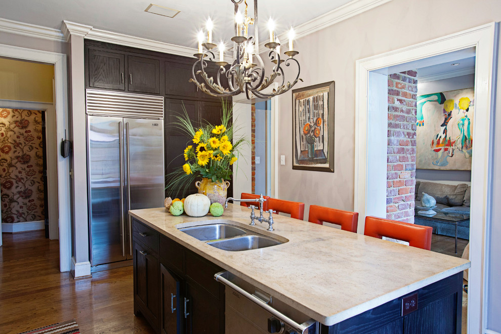 This is an example of an eclectic kitchen in Richmond with limestone benchtops.