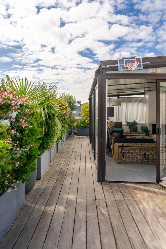 Large contemporary rooftop and rooftop deck in Paris with a container garden, no cover and wood railing.