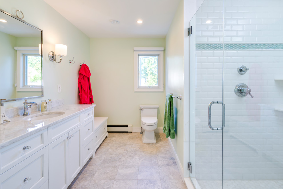 Mid-sized transitional kids bathroom in Philadelphia with shaker cabinets, white cabinets, an alcove shower, a two-piece toilet, white tile, subway tile, white walls, ceramic floors, an undermount sink, marble benchtops, beige floor, a hinged shower door, beige benchtops, a shower seat, a single vanity and a freestanding vanity.