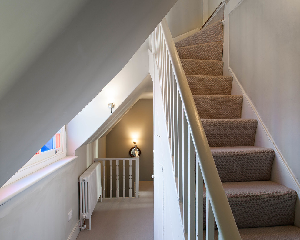 This is an example of a mid-sized country hallway in Cambridgeshire with grey walls, carpet and beige floor.