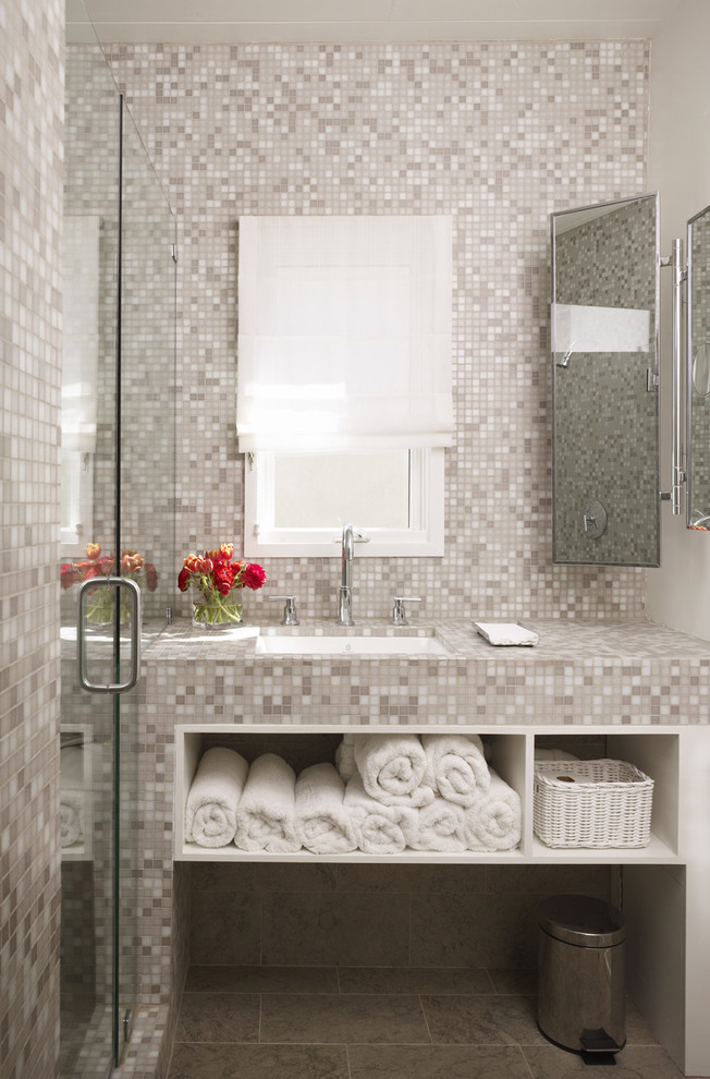 Contemporary bathroom in Los Angeles with an undermount sink, open cabinets, tile benchtops, an alcove shower, gray tile and mosaic tile.