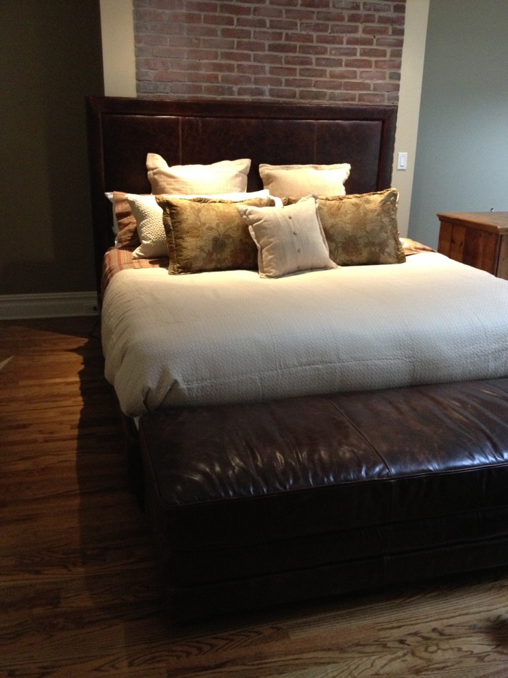 Design ideas for a mid-sized mediterranean master bedroom in New York with brown walls and dark hardwood floors.