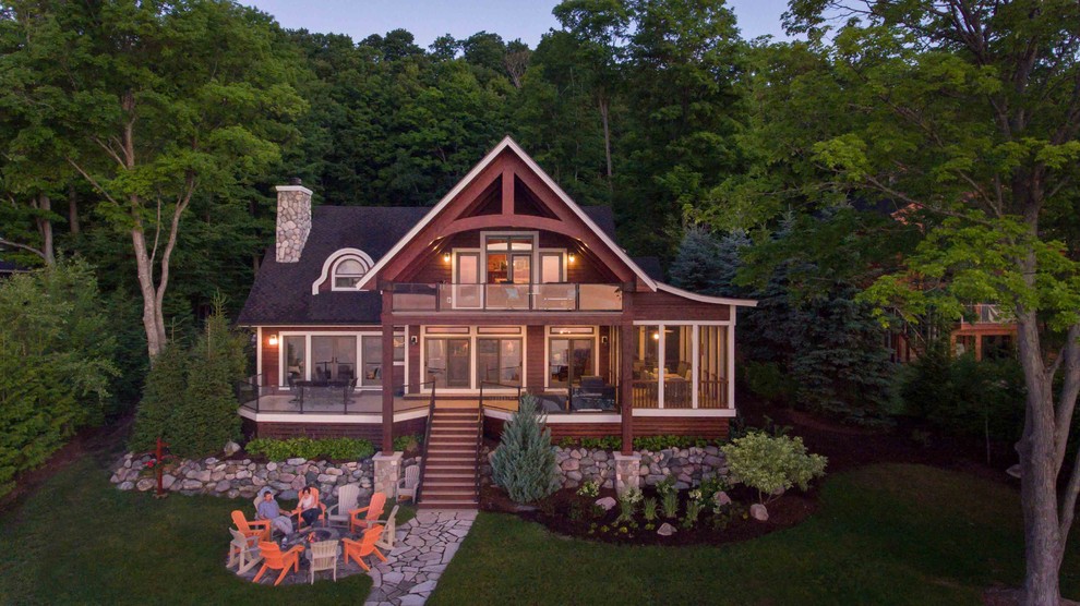 Inspiration for a country two-storey brown house exterior in Other with wood siding and a shingle roof.
