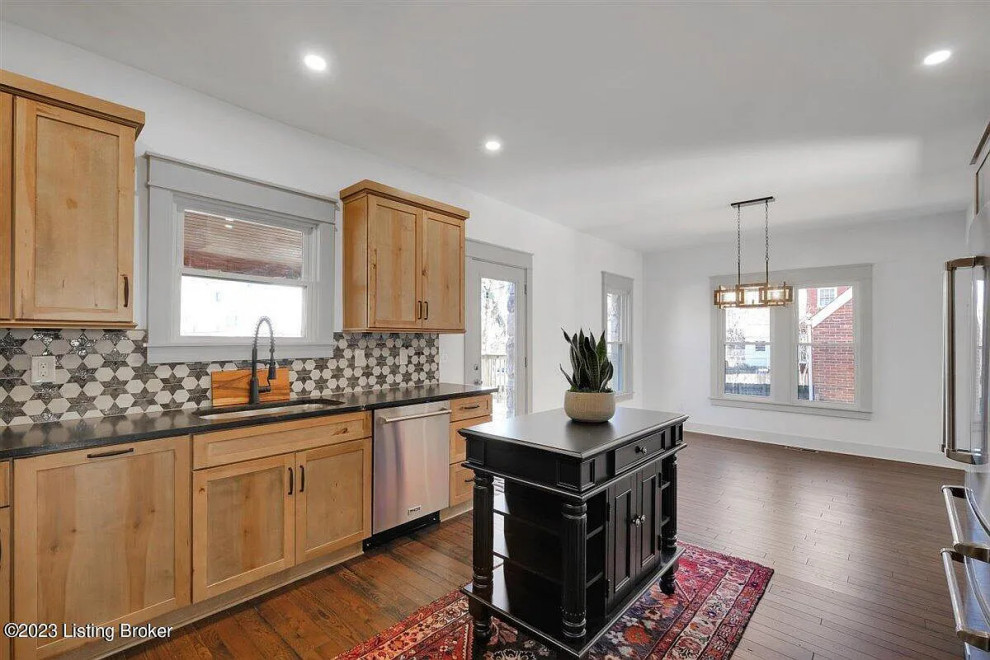 Inspiration for a transitional medium tone wood floor kitchen remodel with an undermount sink, shaker cabinets, light wood cabinets and an island