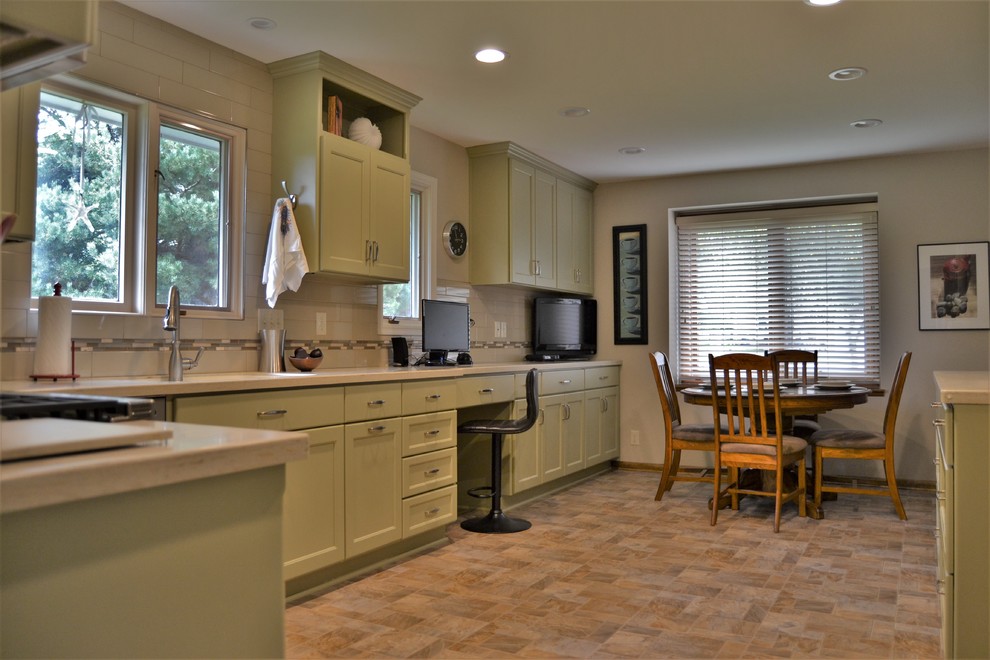Example of a mid-sized transitional l-shaped ceramic tile and beige floor eat-in kitchen design with an undermount sink, shaker cabinets, green cabinets, white backsplash, subway tile backsplash, stainless steel appliances and no island