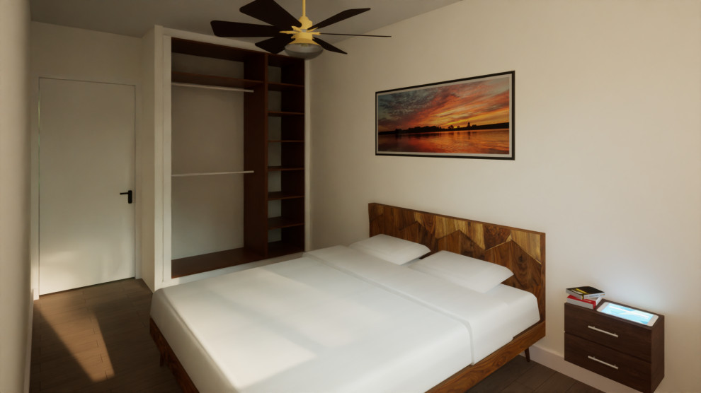 This is an example of a mid-sized tropical guest bedroom in Paris with white walls, dark hardwood floors and brown floor.