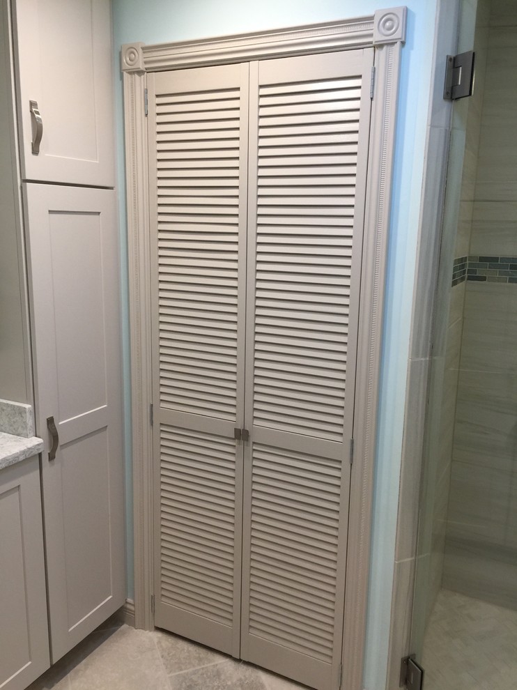 Walk-in shower - mid-sized transitional gray tile and porcelain tile ceramic tile and gray floor walk-in shower idea in Phoenix with shaker cabinets, white cabinets, blue walls, an undermount sink, granite countertops and a hinged shower door