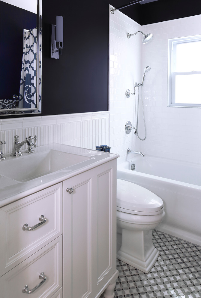 Photo of a mid-sized traditional bathroom in New York with an integrated sink, white cabinets, an alcove tub, a shower/bathtub combo, white tile, mosaic tile floors, furniture-like cabinets, ceramic tile and black walls.