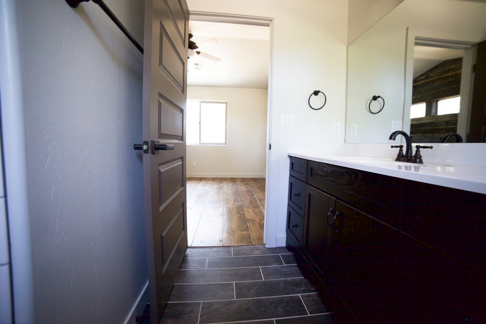 Photo of a small country master bathroom in Phoenix with dark wood cabinets, white tile, porcelain tile, grey walls and porcelain floors.