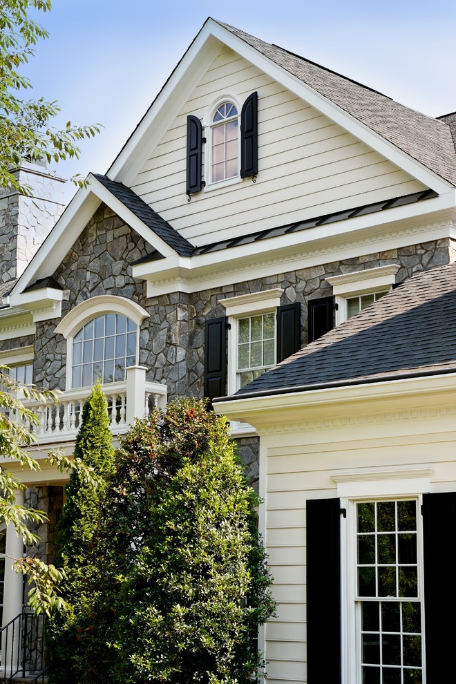 Photo of a large traditional two-storey grey exterior in DC Metro with mixed siding and a gable roof.