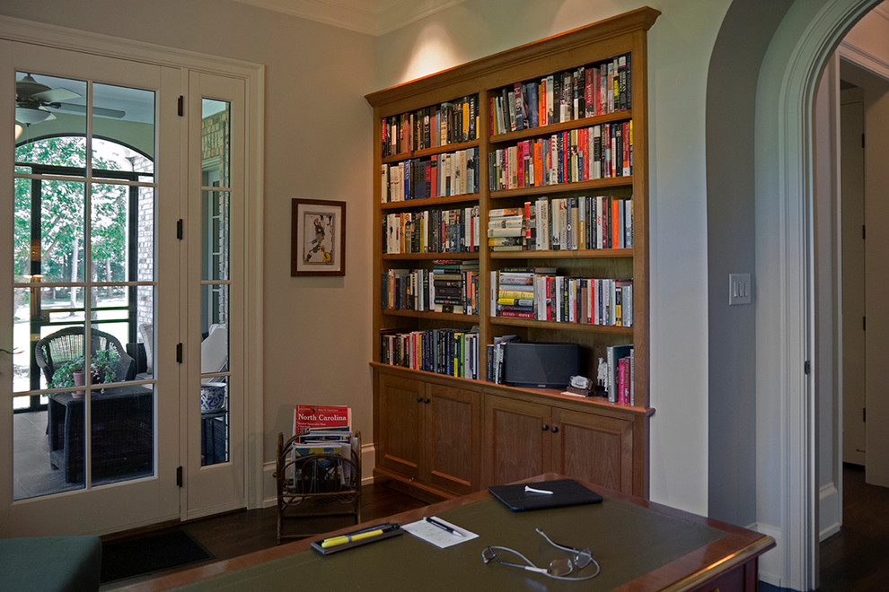 Traditional study room in Raleigh with dark hardwood floors.