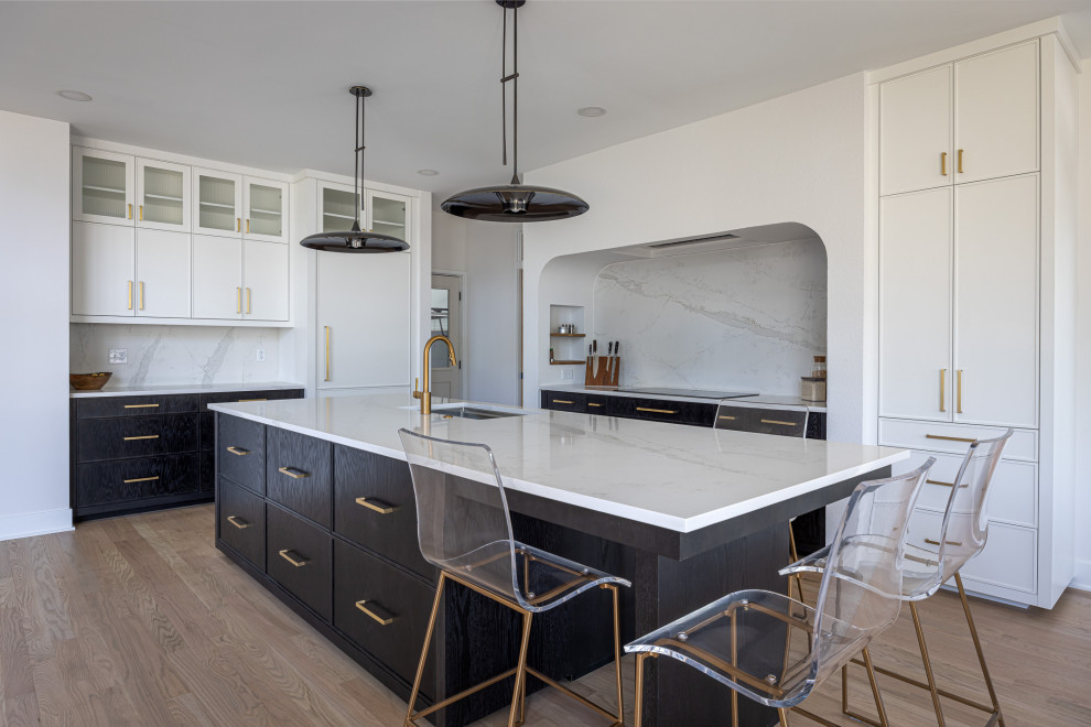 Open concept kitchen - large transitional medium tone wood floor open concept kitchen idea in Raleigh with an undermount sink, beaded inset cabinets, white cabinets, quartz countertops, white backsplash, quartz backsplash, paneled appliances, an island and white countertops