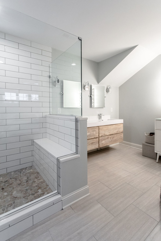 Photo of a mid-sized transitional master bathroom in Minneapolis with flat-panel cabinets, medium wood cabinets, an alcove shower, white tile, ceramic tile, grey walls, porcelain floors, an undermount sink, engineered quartz benchtops, beige floor, an open shower and white benchtops.