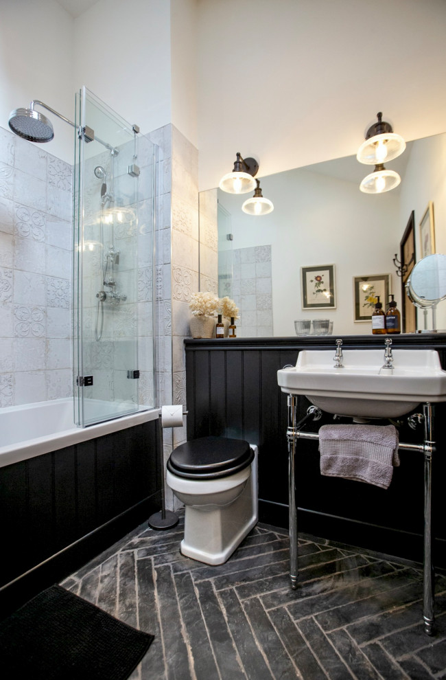 Inspiration for a small traditional kids bathroom in Other with a drop-in tub, a shower/bathtub combo, a one-piece toilet, porcelain floors, black floor, a single vanity and planked wall panelling.