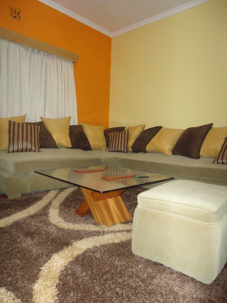 This is an example of a small modern enclosed living room in Other with orange walls, carpet and no fireplace.