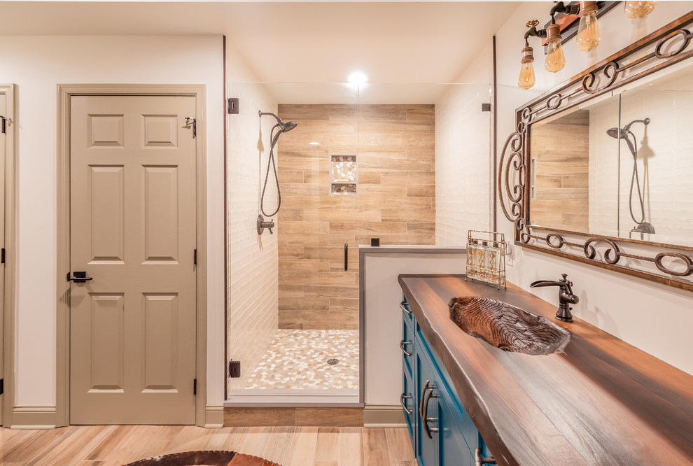Photo of a large country 3/4 bathroom in Philadelphia with shaker cabinets, turquoise cabinets, an alcove shower, a one-piece toilet, brown tile, porcelain tile, white walls, laminate floors, an integrated sink, concrete benchtops, brown floor, a hinged shower door and brown benchtops.