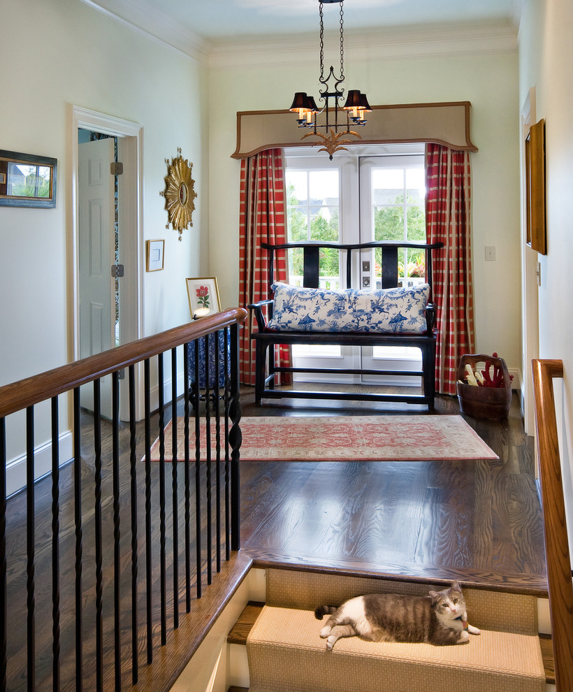 Photo of a traditional hallway in Charleston with white walls and dark hardwood floors.