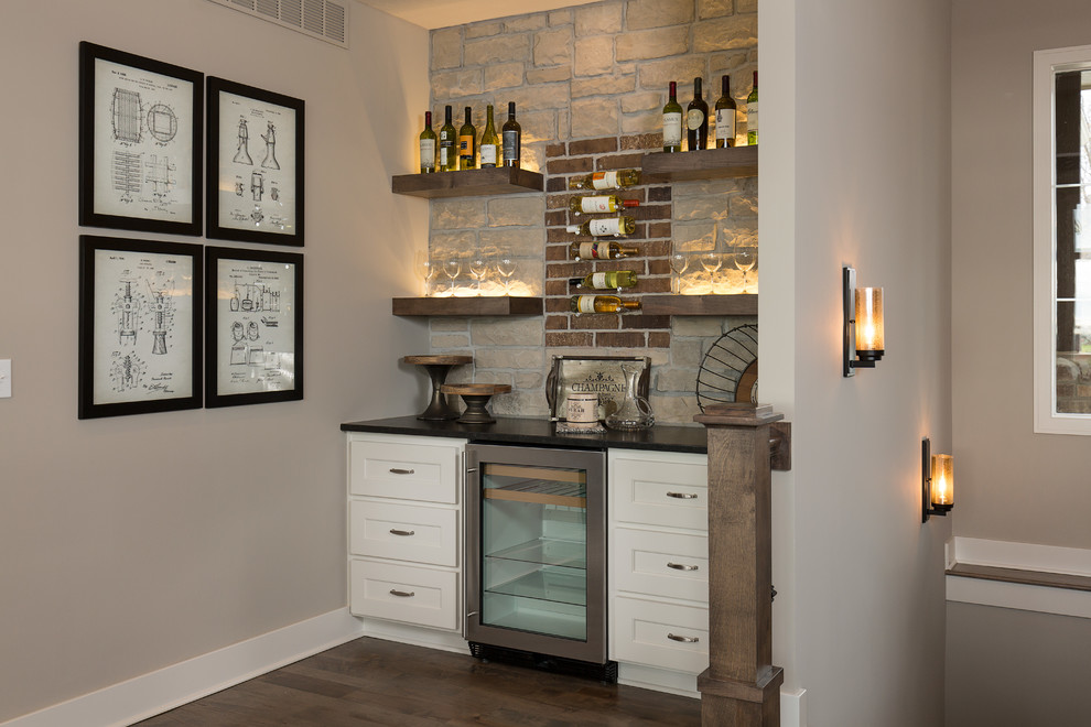 Inspiration for an arts and crafts single-wall home bar in Kansas City with shaker cabinets, white cabinets, red splashback, brick splashback and dark hardwood floors.