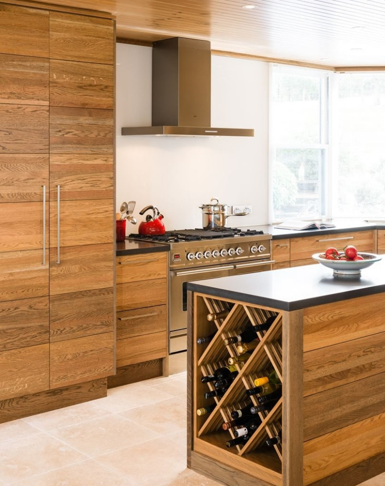 Mid-sized scandinavian l-shaped open plan kitchen in Melbourne with a double-bowl sink, flat-panel cabinets, medium wood cabinets, quartz benchtops, white splashback, glass sheet splashback, stainless steel appliances, porcelain floors, multiple islands and black benchtop.