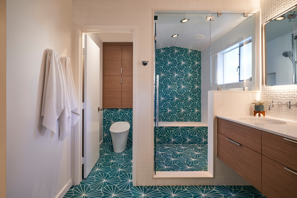 Design ideas for a mid-sized midcentury master bathroom in San Diego with flat-panel cabinets, medium wood cabinets, an alcove shower, a bidet, blue tile, cement tile, white walls, cement tiles, an undermount sink, engineered quartz benchtops, turquoise floor, a hinged shower door, white benchtops, an enclosed toilet, a double vanity and a built-in vanity.